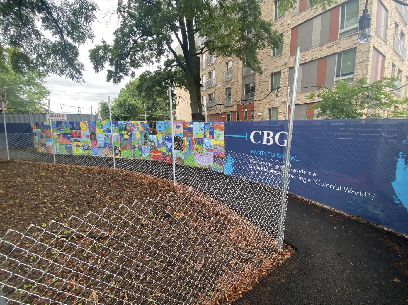 second grade art creates a colorful mosaic-style mural in a construction walkway on glebe rd.