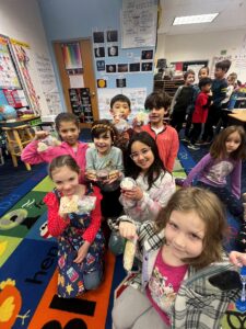 A group of 1st graders with the sweet treats from the SCA bake sale