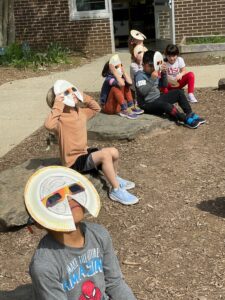 Students look at the eclipse